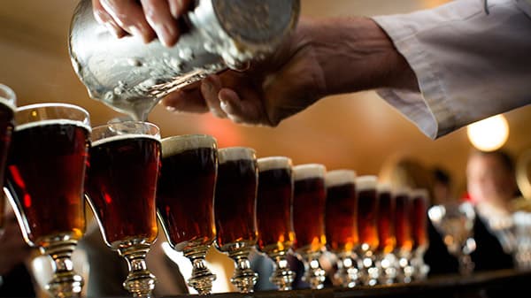 Bartender crafting original Irish Coffees in a row at Buena Vista